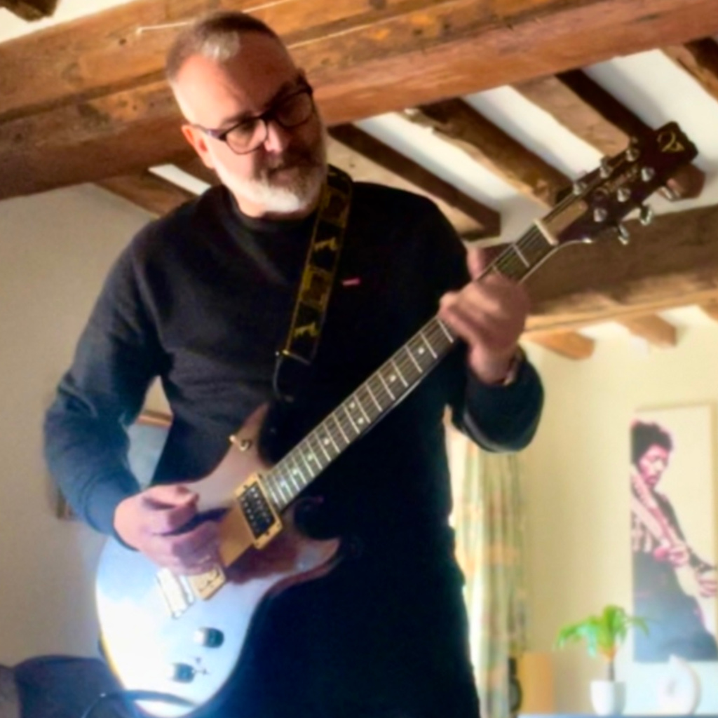 Lee playing electric guitar